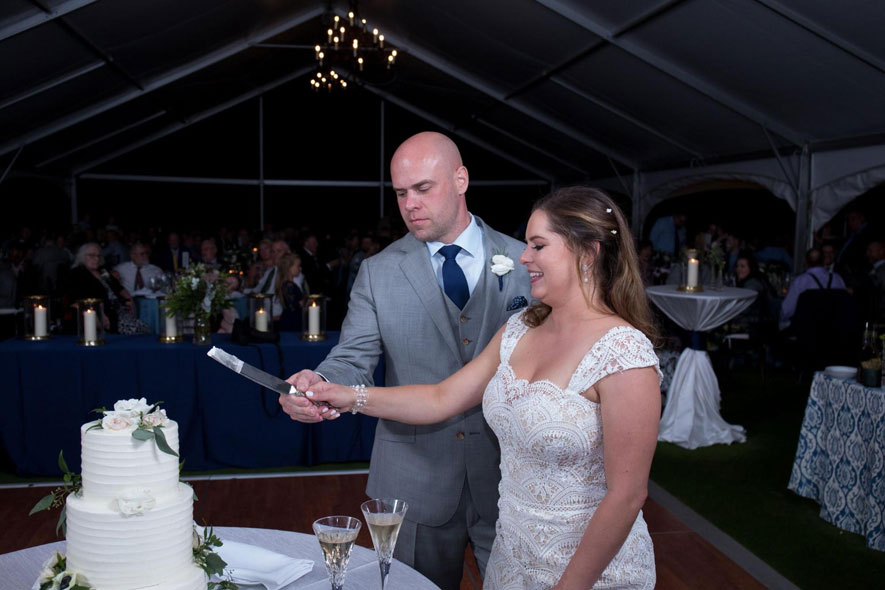 Bride and Groom Cut the Cake at Wedding Reception